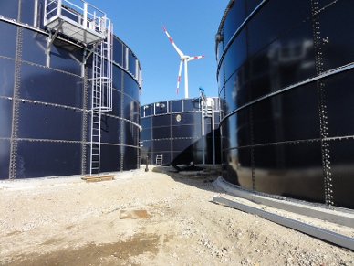 Wind Turbine behind Tanks